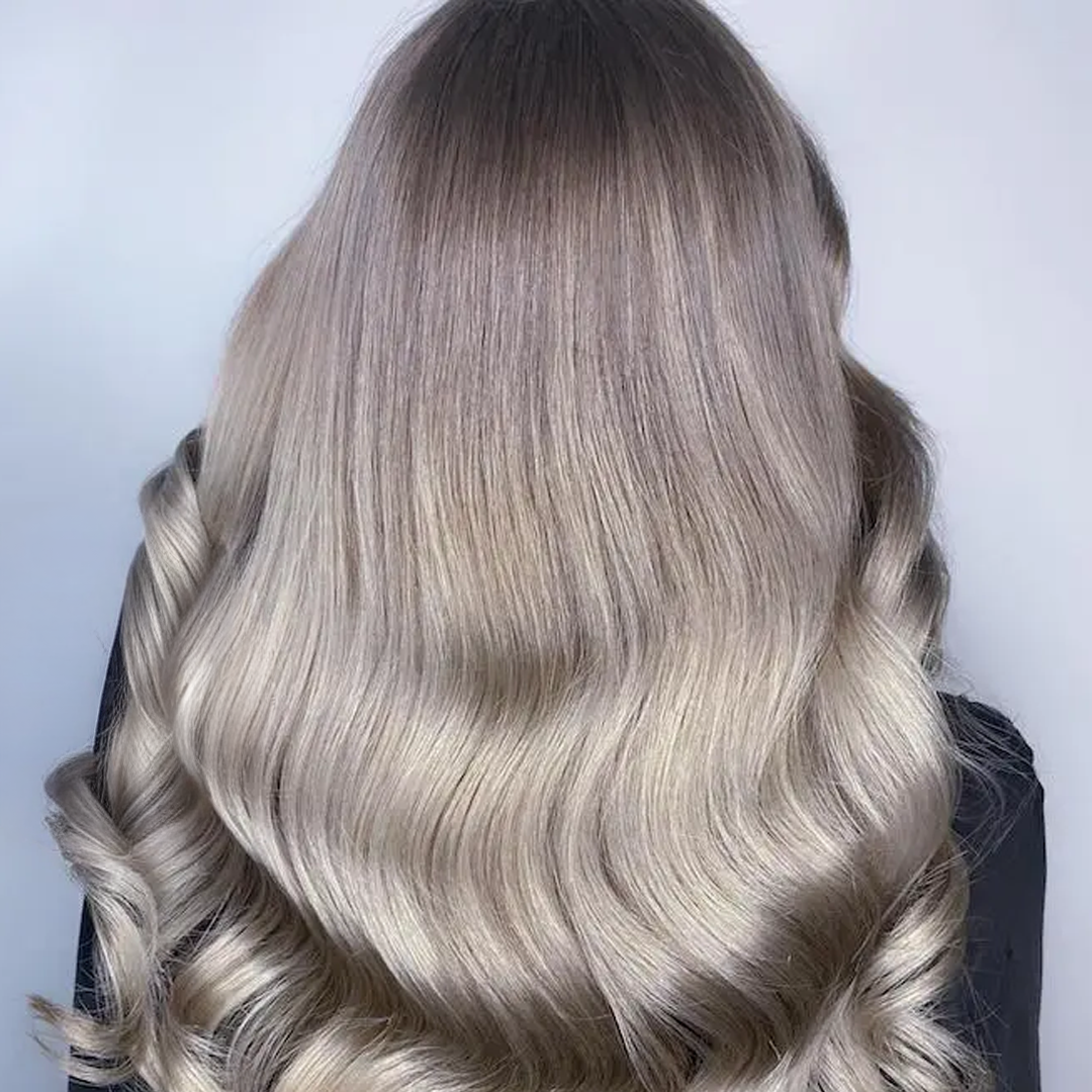 Mushroom blonde hair color with soft layers, trendy fall 2025 hairstyle, cool neutral tones with subtle highlights.
